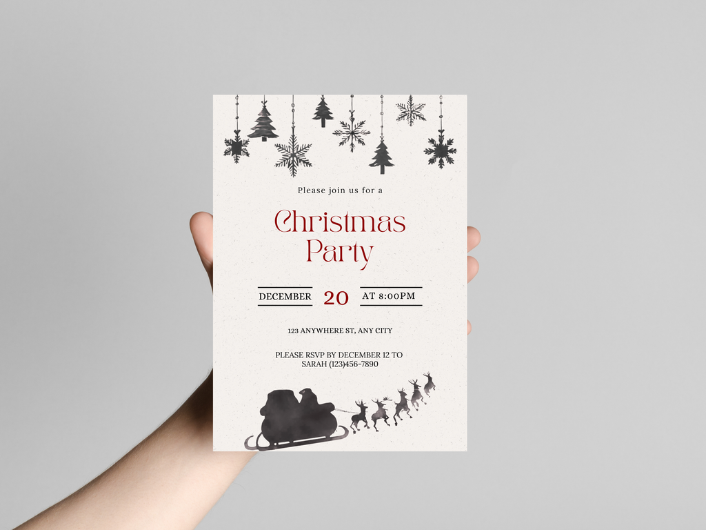 Hand holding a Christmas party invitation with festive designs on a gray background