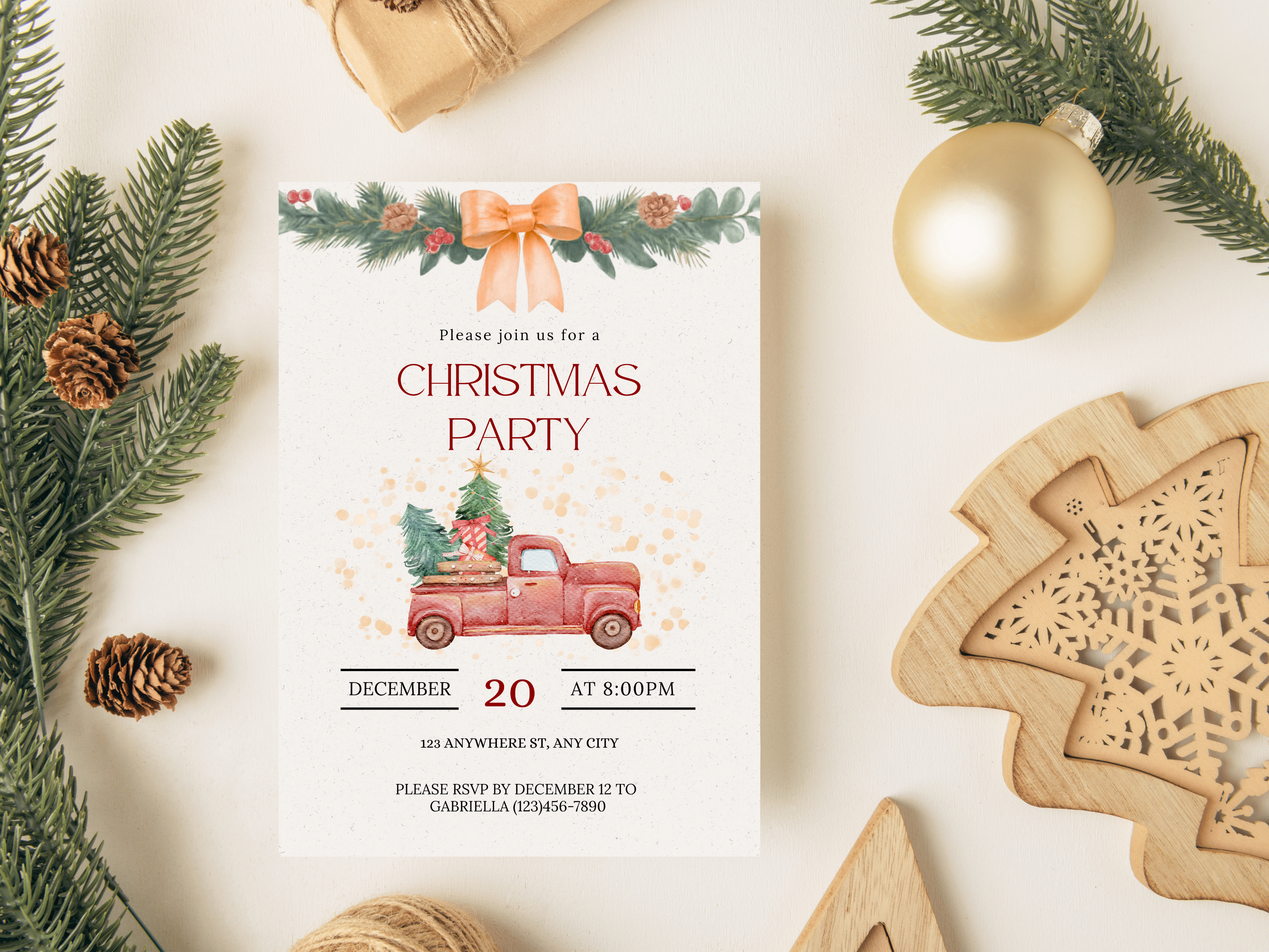 Christmas party invitation with a red truck and tree design, surrounded by festive decorations on a white surface.