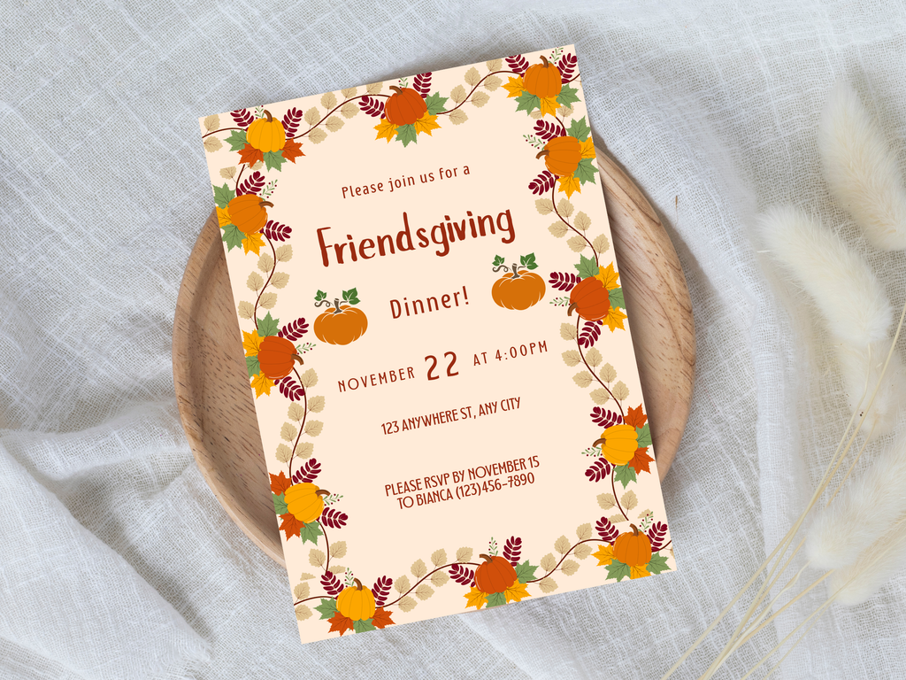 Friendsgiving dinner invitation card with pumpkins and leaves on a white surface