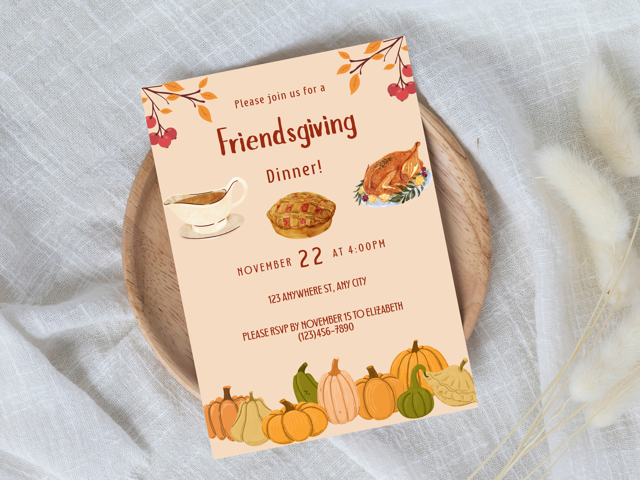 Friendsgiving dinner invitation with pumpkins and a turkey on a white fabric background