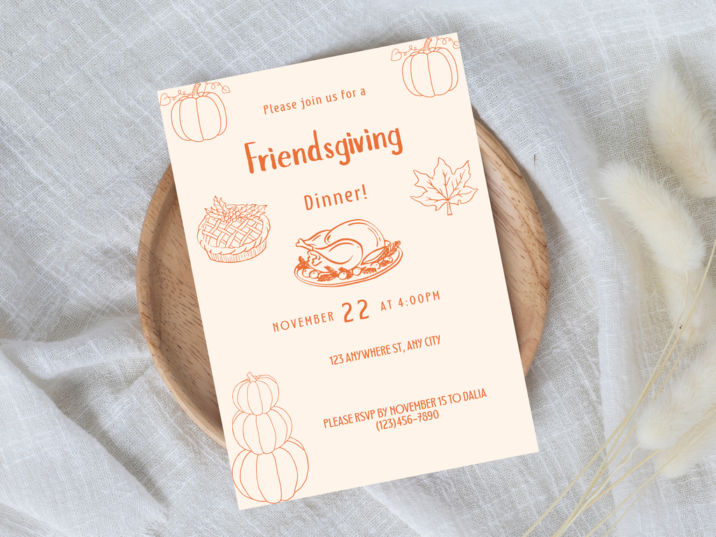 Friendsgiving dinner invitation card on a wooden plate with a light gray background