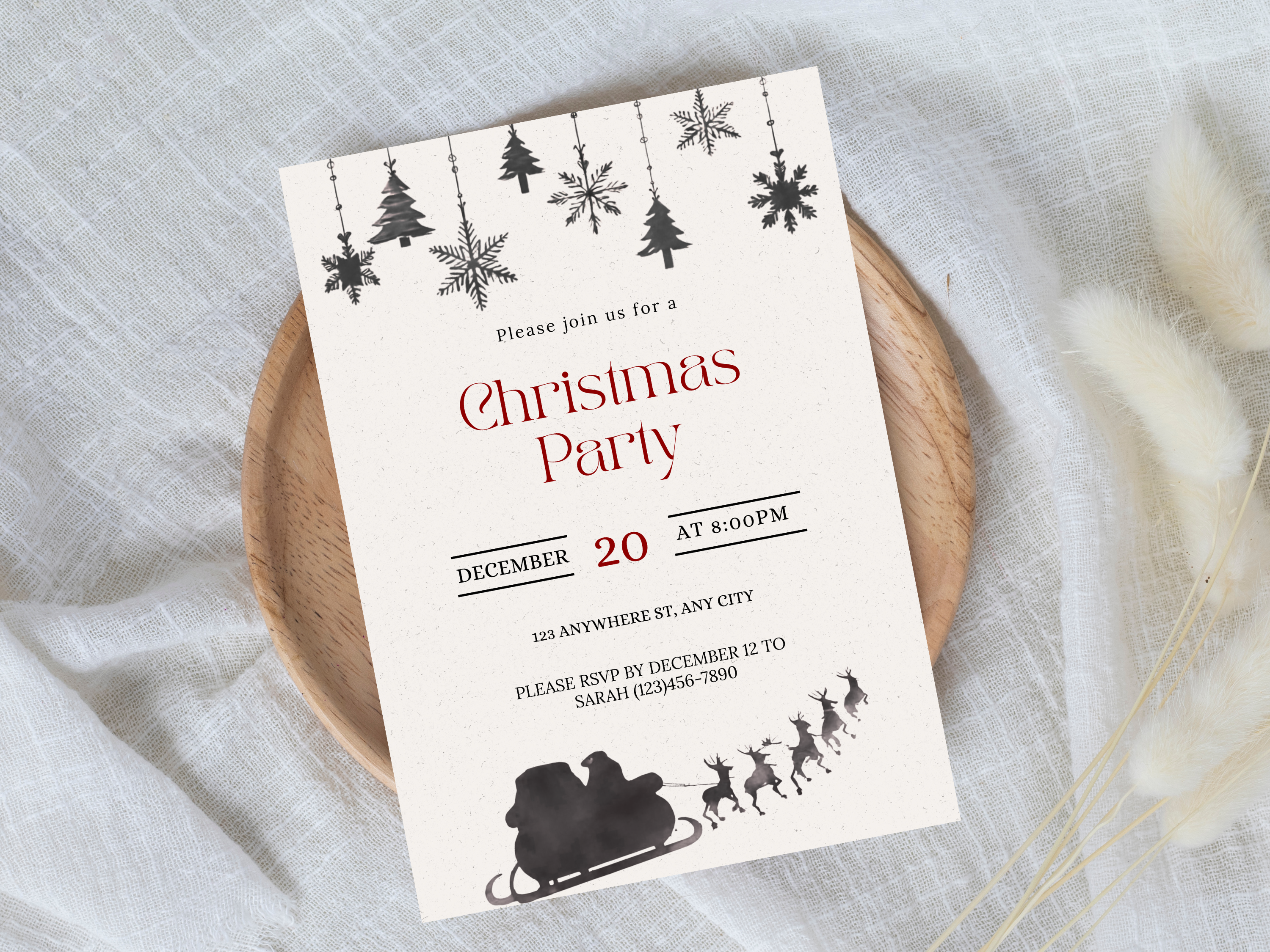 Christmas party invitation card with festive design on a light fabric background
