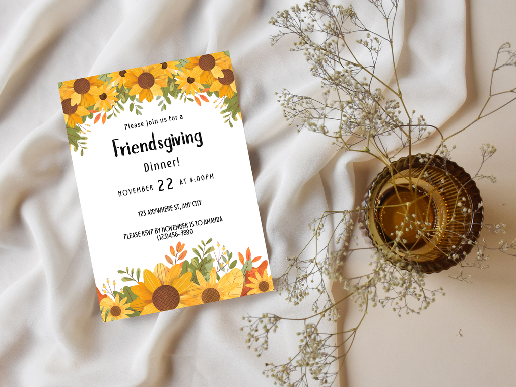 Friendsgiving dinner invitation card with sunflower design on a white fabric background