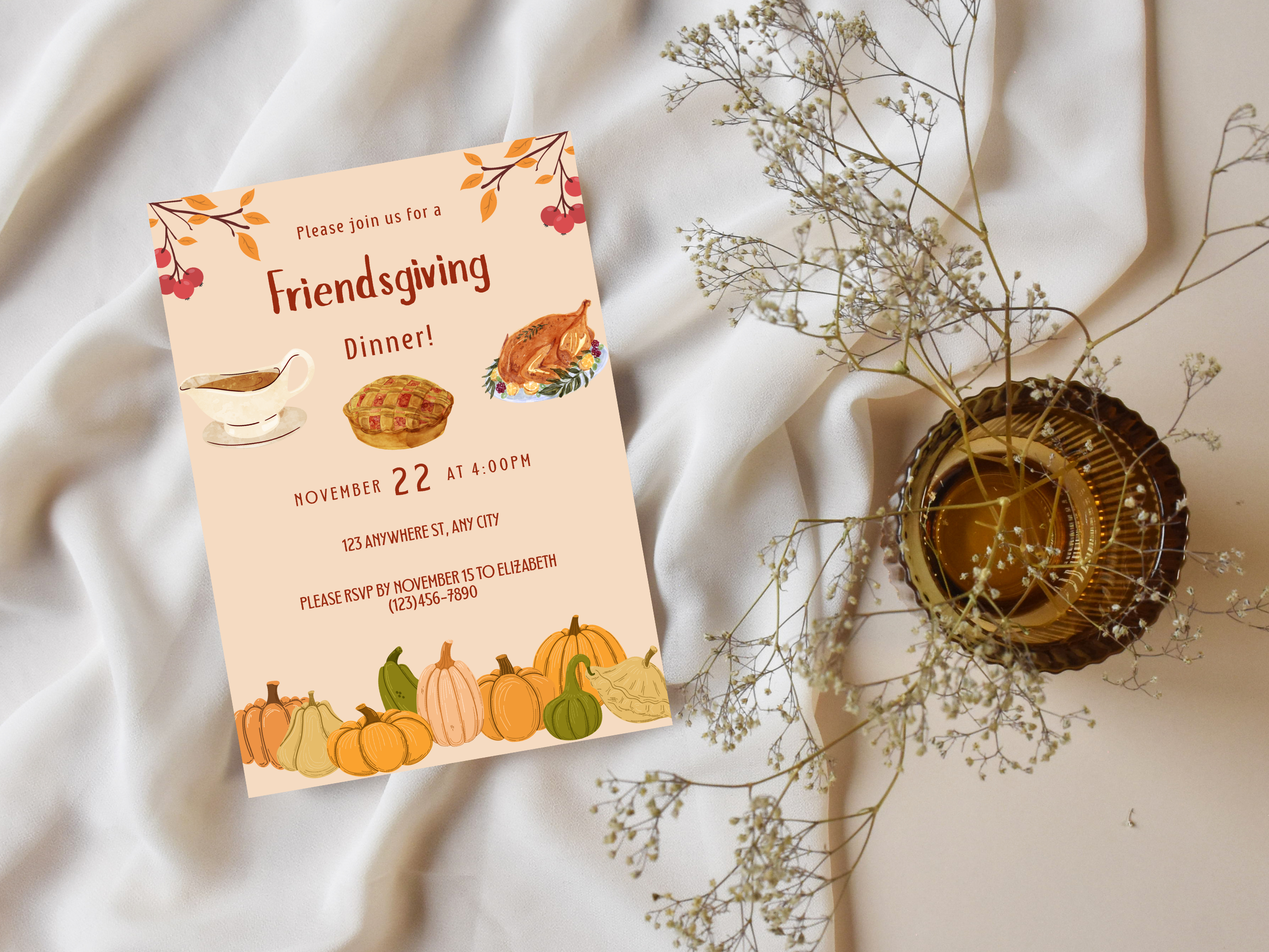 Friendsgiving dinner invitation with fall-themed graphics on a soft fabric background