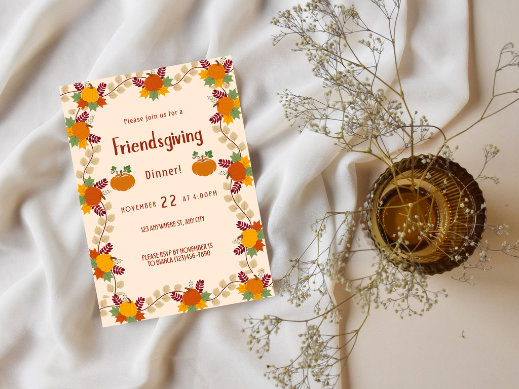 Friendsgiving dinner invitation card with autumnal design on a soft fabric background