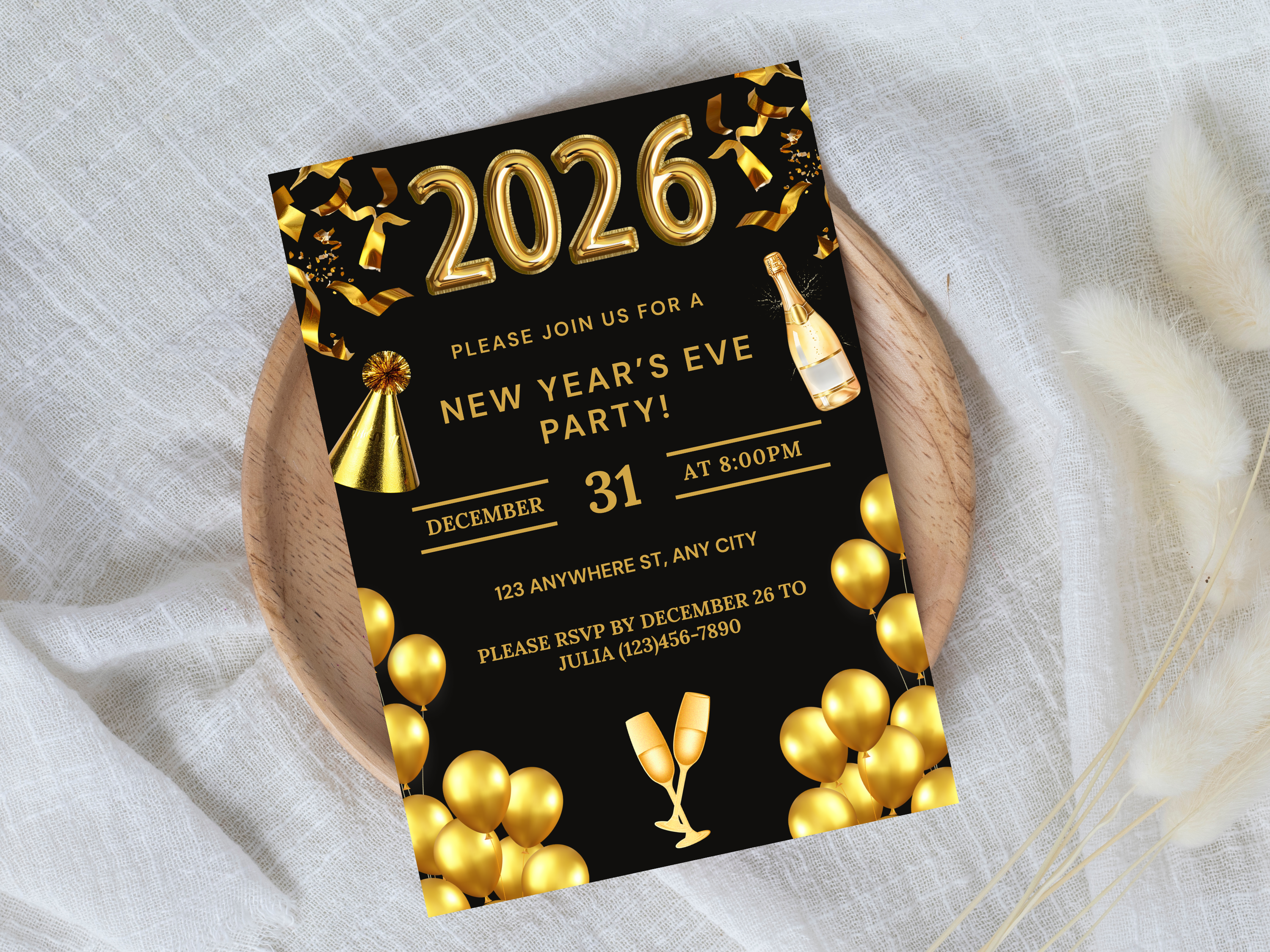New Year's Eve party invitation with gold balloons and champagne bottle on a white fabric background